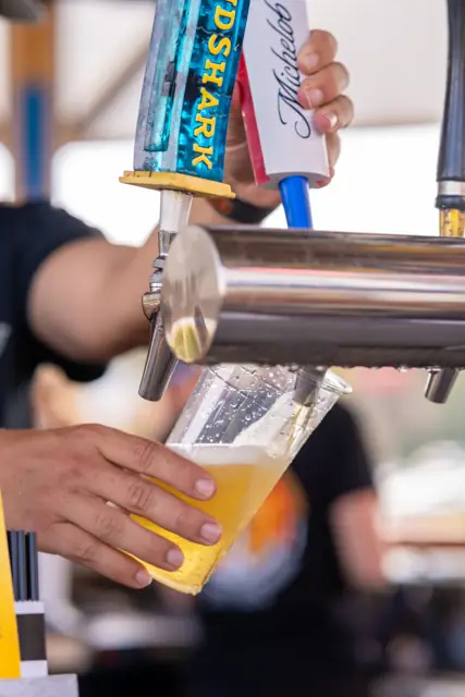 A draft beer being poured at the tap