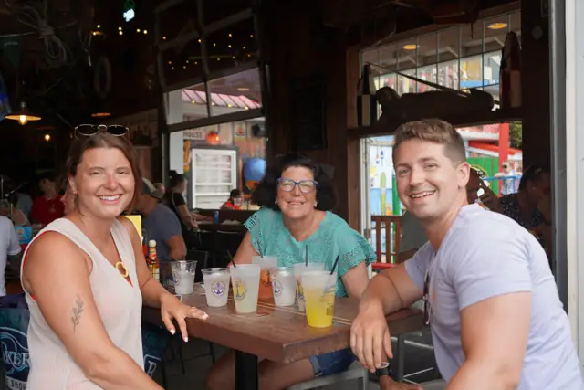 Three friends smiling over a table of crushes