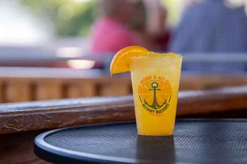 Fresh orange crush in a Boathouse cup on the bar