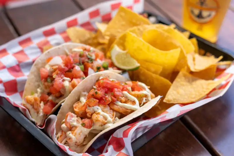 Shrimp tacos with chips and lime